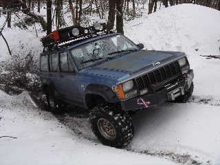 Blue Jeep Cherokee in snowy Long Island Off Road