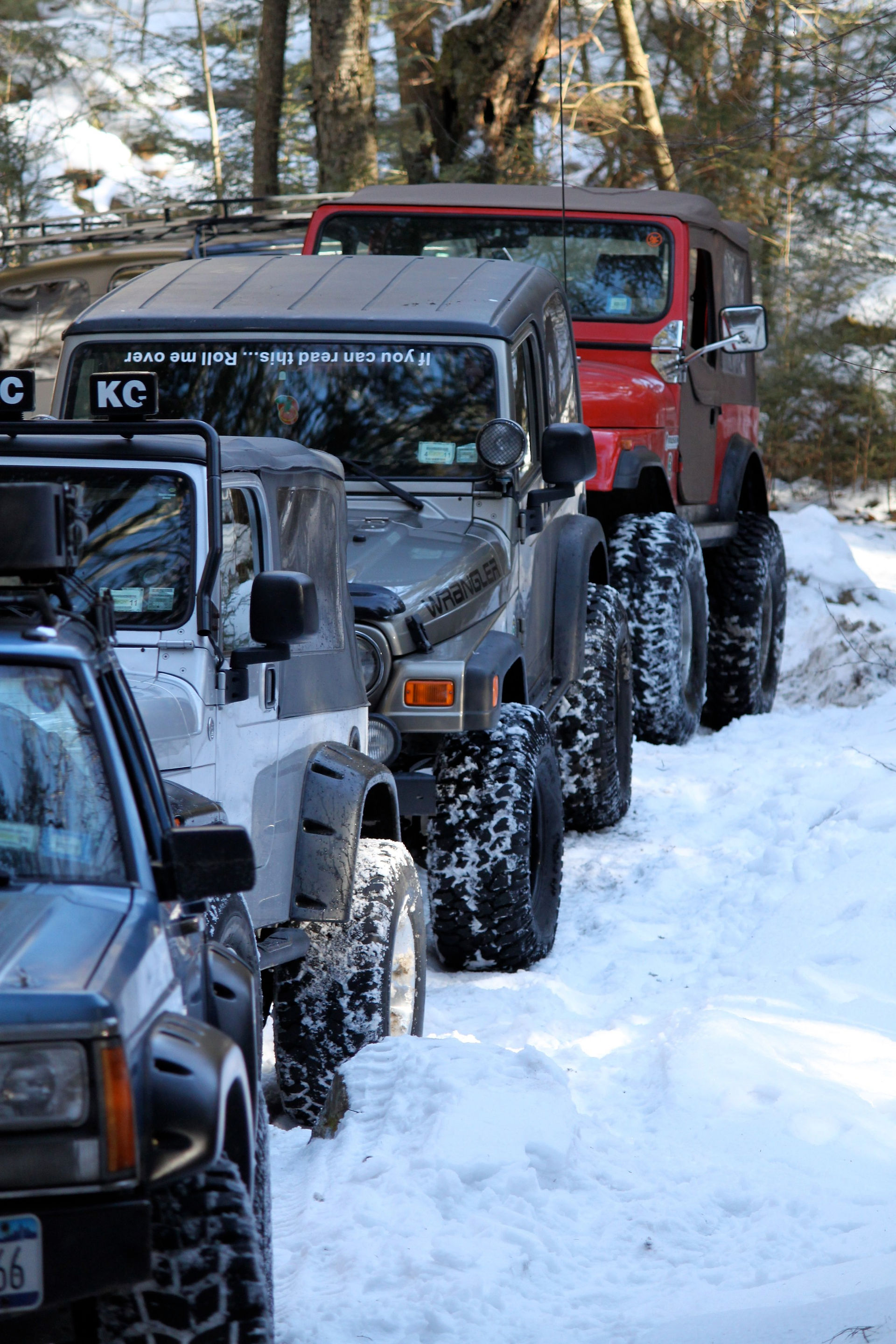 Jeeps driving in snowy terrain