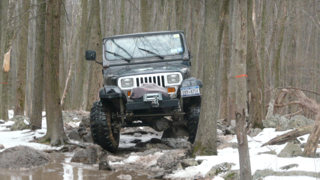 Jeep navigating snowy trail