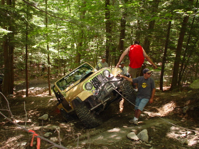 Jeep stuck in woods, men pulling