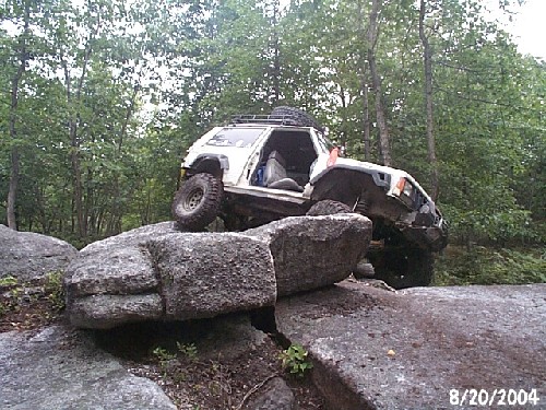 White Jeep on rocks, off-roading