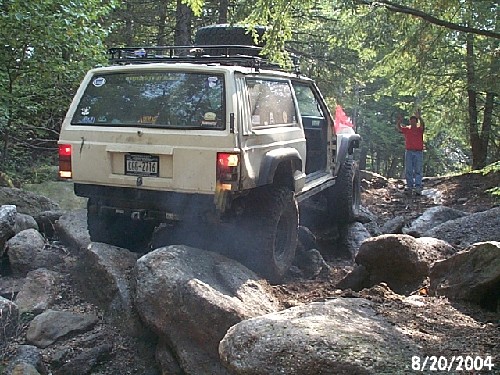 Off-road Jeep navigating rocks; photographer present