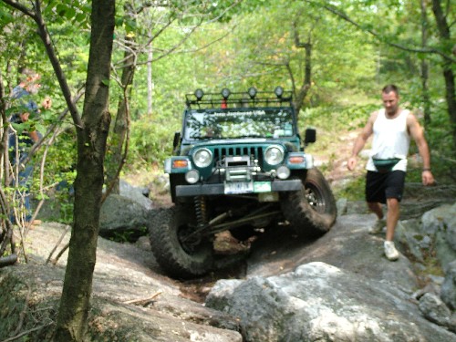 Man guiding Jeep over rocks, Long Island Off Road