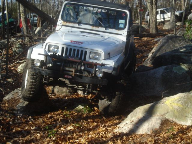 White Jeep navigating rocky terrain
