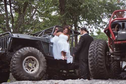 Bride and groom with off-road vehicle