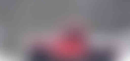 Man driving red Jeep truck in snowy woods