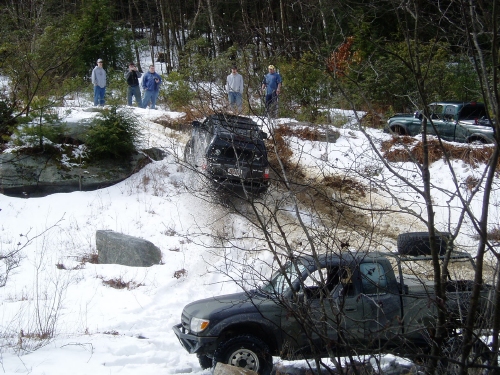 Off-road vehicles navigating snowy terrain