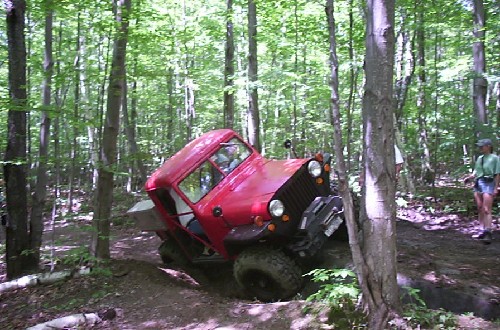 Red Jeep stuck in woods