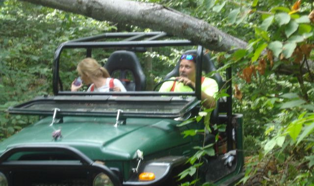 Two women enjoying off-road adventure in a green Jeep