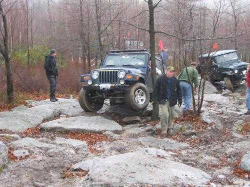 Jeep navigating rocky terrain; off-road adventure