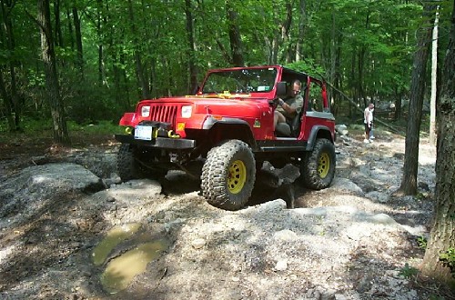 Red Jeep traversing rocks, Long Island Off Road