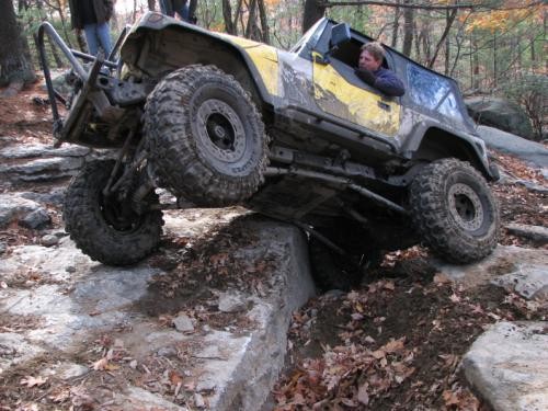 Man driving modified Jeep over rocks