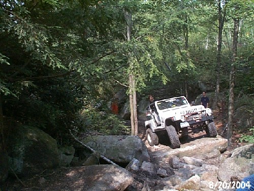 White Jeep navigating rocky trail, Long Island Off Road