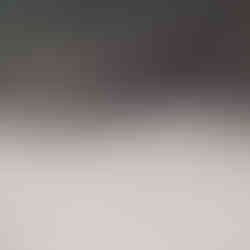 Red truck driving on sandy beach