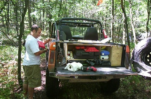 Man refueling off-road vehicle