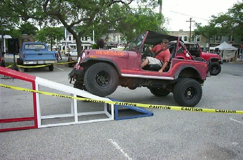 Man driving red Jeep CJ on ramp