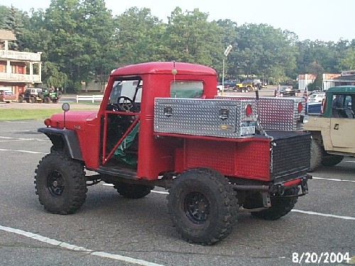 Red vintage Jeep truck with toolboxes