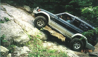 Person driving modified Mitsubishi Montero off-road