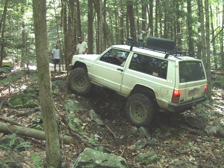 White Jeep navigating rocky trail