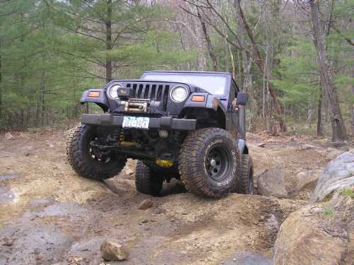 Jeep navigating rocky off-road trail