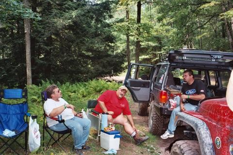Three men relax by a Jeep, Long Island Off Road