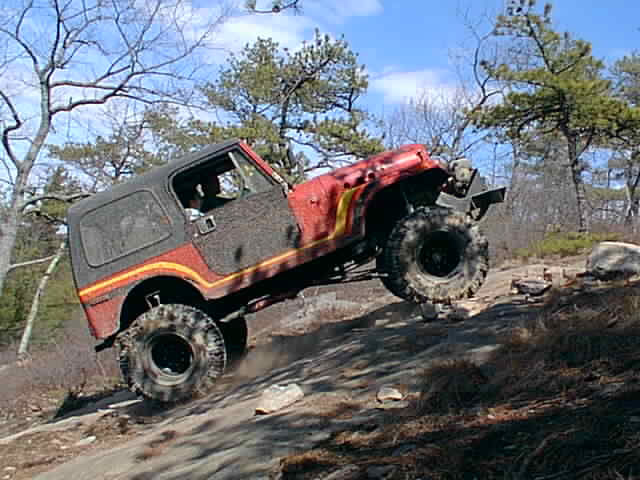 Red Jeep CJ overcoming obstacle, Long Island Off Road