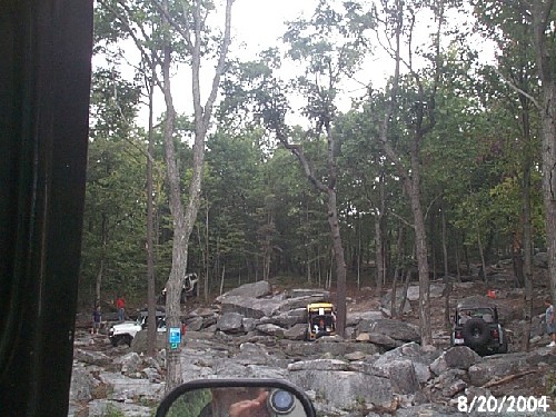 Off-road vehicles among rocks and trees