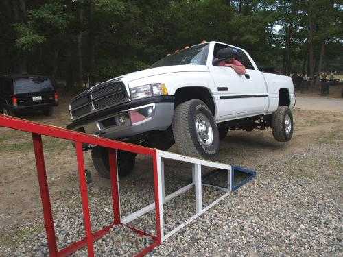 White Dodge Ram truck driving over a ramp