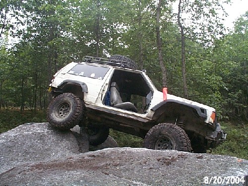 White Jeep on rocks, off-roading