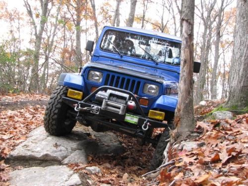 Blue Jeep navigating rocky trail
