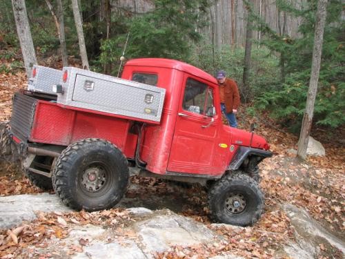Red truck on rocky trail