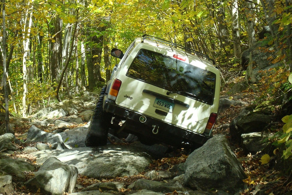 Jeep traversing rocky stream bed