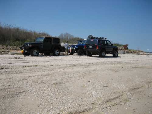 Jeeps and people on beach