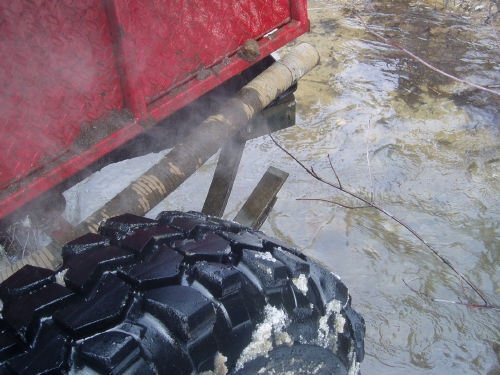 Muddy off-road vehicle tire and exhaust
