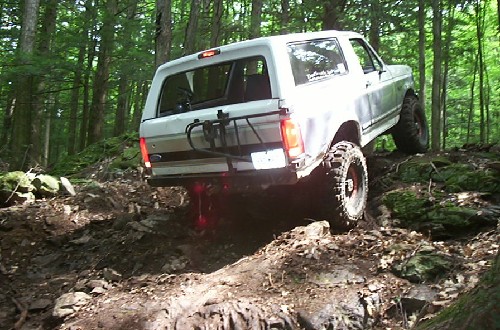 White Ford Bronco traversing rocky terrain