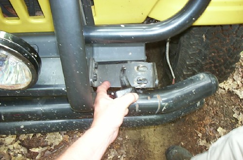 Hand pointing at Jeep's front bumper