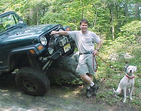 Man with Jeep and dog off-roading