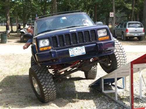 Jeep Cherokee ascending ramp at off-road event