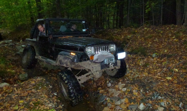 Black Jeep navigating rocky trail