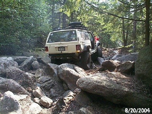 White Jeep Cherokee navigating rocky terrain