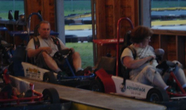 Two adults go-kart racing