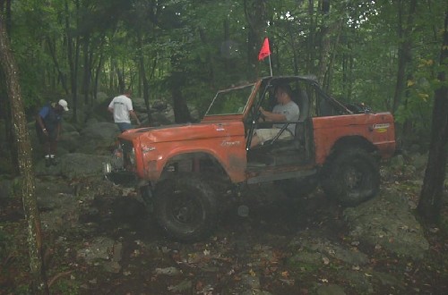 Orange Ford Bronco off-roading
