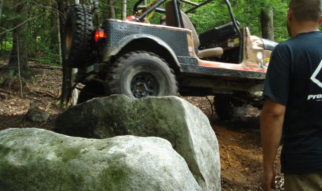Jeep traversing rocks on trail