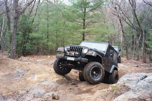 Black Jeep navigating rocky terrain