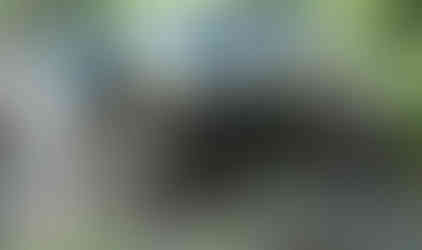 Blue Jeep tackling muddy off-road trail