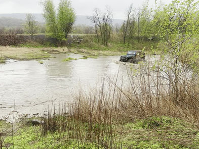 Jeep crossing a pond.