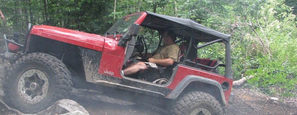 Red Jeep on rocky trail