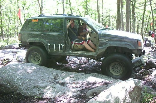 Two men in Jeep Cherokee off-roading