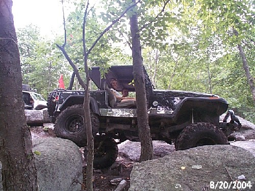 Man driving Jeep on rocky Long Island trail
