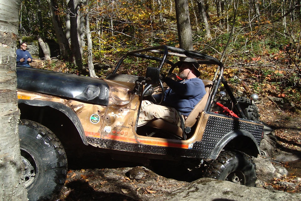 Man driving a Jeep on a rocky trail